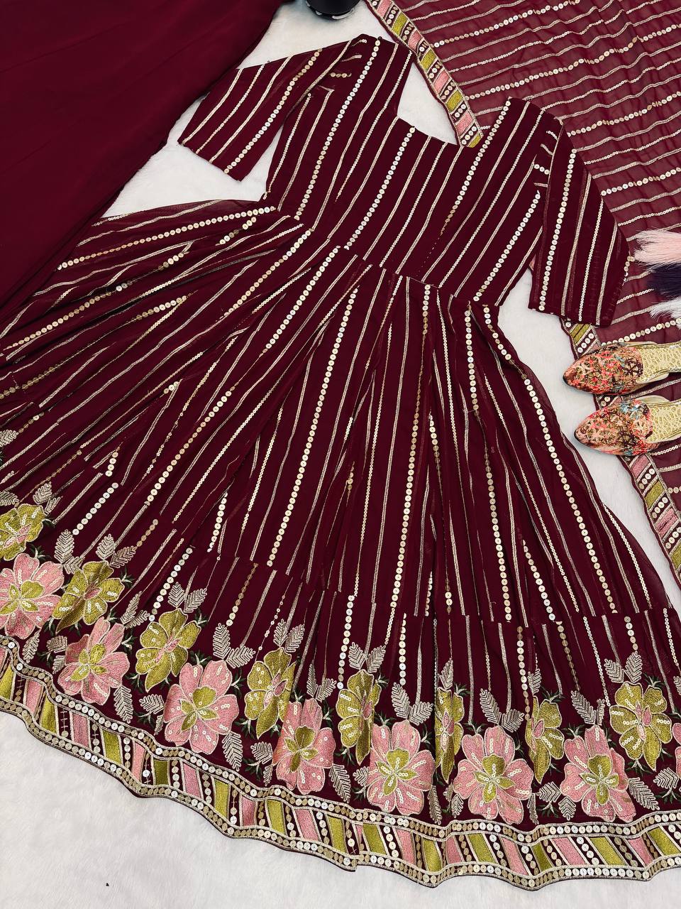 Majestic Maroon Flared Anarkali Suit Set Adorned with Luminous Sequin Stripes and an Ornate Floral Embroidered Hemline
